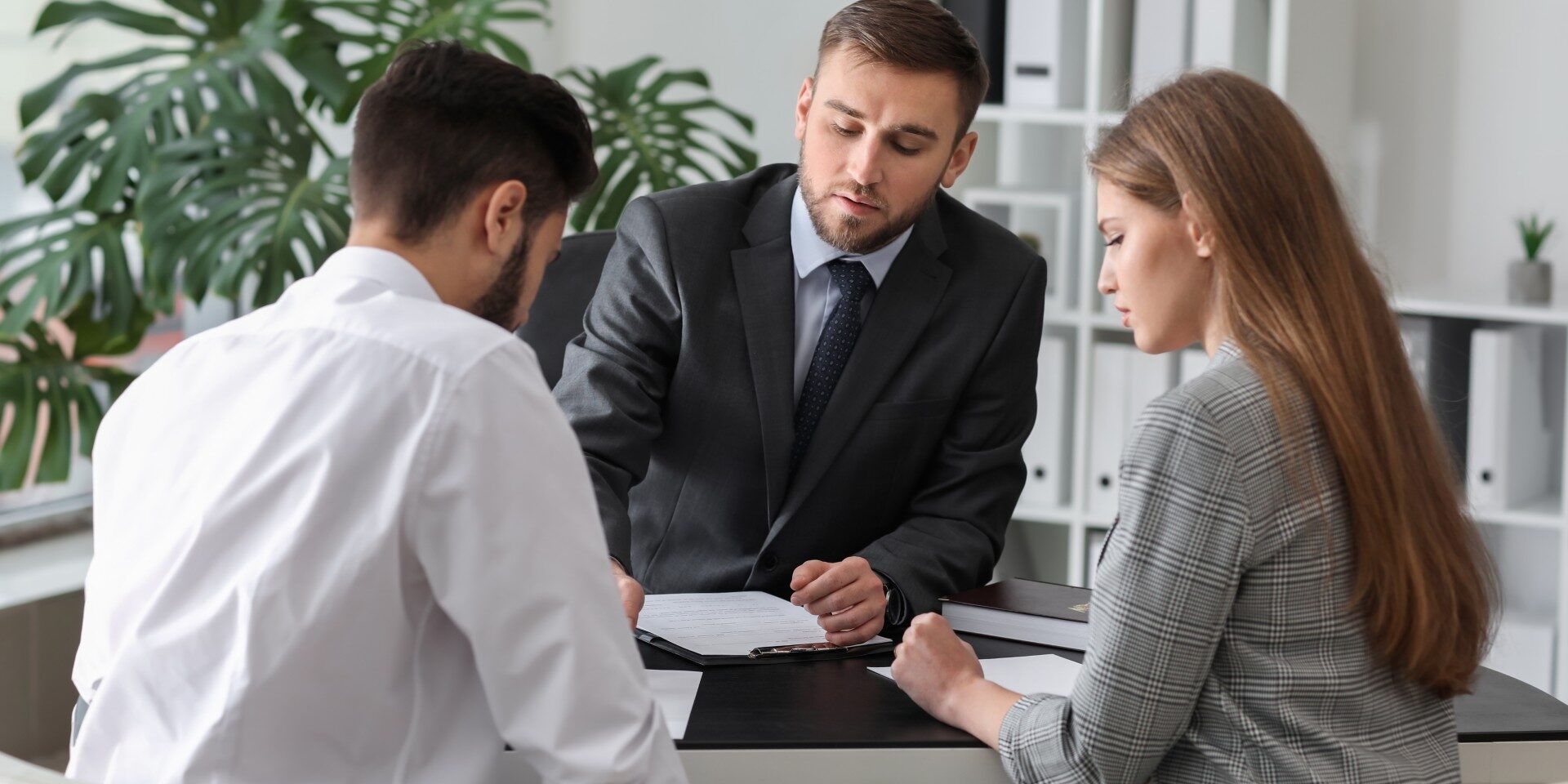 Unhappy young couple visiting divorce lawyer in office Unhappy young couple visiting divorce lawyer in office