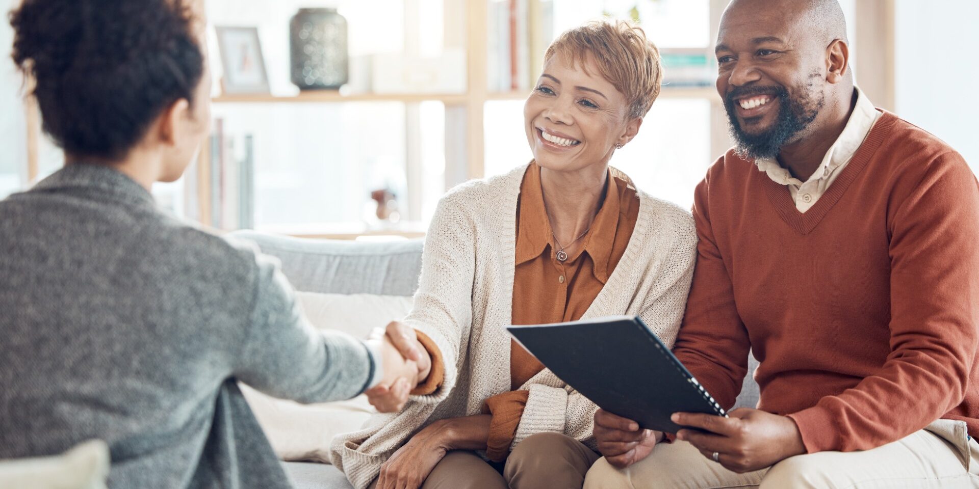 Business meeting, welcome handshake and couple meet with lawyer or financial advisor. Elderly married man, wife and woman retirement conversation, planning and insurance documents for estate finance Business meeting, welcome handshake and couple meet with lawyer or financial advisor. Elderly married man, wife and woman retirement conversation, planning and insurance documents for estate finance.